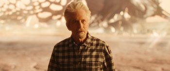 Movie still from “Ant-Man and the Wasp: Quantumania” (2023), directed by Peyton Reed – An older man with white hair wearing a checkered shirt; Medium shot, Over the shoulder angle