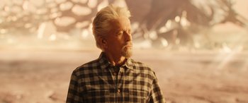 Movie still from “Ant-Man and the Wasp: Quantumania” (2023), directed by Peyton Reed – An older man with white hair wearing a checkered shirt; Close Up shot, Low angle