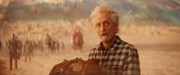 Movie still from “Ant-Man and the Wasp: Quantumania” (2023), directed by Peyton Reed – An old man with a beard and mustache holding a bag; Close Up shot, Over the shoulder angle