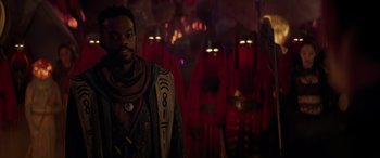 Movie still from “Ant-Man and the Wasp: Quantumania” (2023), directed by Peyton Reed – A man standing in front of a group of people; Medium shot, Over the shoulder angle