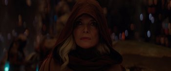Movie still from “Ant-Man and the Wasp: Quantumania” (2023), directed by Peyton Reed – A woman wearing a hooded jacket and a scarf; Close Up shot, Over the shoulder angle