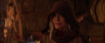 Movie still from “Ant-Man and the Wasp: Quantumania” (2023), directed by Peyton Reed – A woman wearing a hooded jacket and a brown hat; Close Up shot, Over the shoulder angle