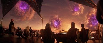 Movie still from “Ant-Man and the Wasp: Quantumania” (2023), directed by Peyton Reed – Two people sitting at a table under a purple sky; Wide shot, Over the shoulder angle