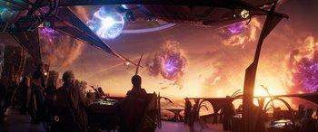 Movie still from “Ant-Man and the Wasp: Quantumania” (2023), directed by Peyton Reed – A man sitting at a table in front of an alien landscape; Extreme Wide shot, Over the shoulder angle