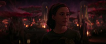 Movie still from “Ant-Man and the Wasp: Quantumania” (2023), directed by Peyton Reed – A woman standing in the dark looking at the camera; Close Up shot, Over the shoulder angle