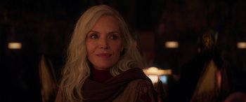 Movie still from “Ant-Man and the Wasp: Quantumania” (2023), directed by Peyton Reed – A woman with long blonde hair wearing a scarf; Close Up shot, Over the shoulder angle
