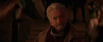 Movie still from “Ant-Man and the Wasp: Quantumania” (2023), directed by Peyton Reed – An older man with white hair and a gray beard; Close Up shot, Over the shoulder angle