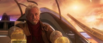 Movie still from “Ant-Man and the Wasp: Quantumania” (2023), directed by Peyton Reed – An older man with a white beard holding a glass of beer; Close Up shot, Over the shoulder angle
