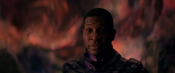 Movie still from “Ant-Man and the Wasp: Quantumania” (2023), directed by Peyton Reed – A person wearing a suit; Close Up shot, Over the shoulder angle