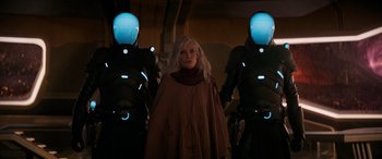 Movie still from “Ant-Man and the Wasp: Quantumania” (2023), directed by Peyton Reed – A woman standing next to two robots in a dark room; Medium shot, Over the shoulder angle