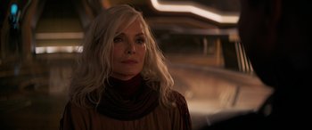 Movie still from “Ant-Man and the Wasp: Quantumania” (2023), directed by Peyton Reed – A woman with long white hair wearing a brown dress; Close Up shot, Over the shoulder angle