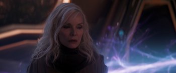 Movie still from “Ant-Man and the Wasp: Quantumania” (2023), directed by Peyton Reed – A woman with long blonde hair wearing a black scarf; Close Up shot, Over the shoulder angle