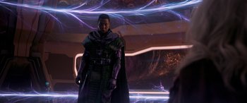 Movie still from “Ant-Man and the Wasp: Quantumania” (2023), directed by Peyton Reed – A man standing in front of an electric background; Medium shot, Over the shoulder angle