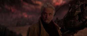 Movie still from “Ant-Man and the Wasp: Quantumania” (2023), directed by Peyton Reed – An older man with white hair and a gray beard; Close Up shot, Over the shoulder angle