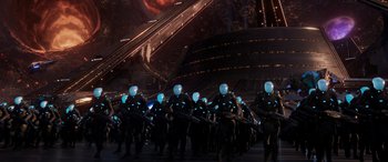 Movie still from “Ant-Man and the Wasp: Quantumania” (2023), directed by Peyton Reed – A group of people in black suits and helmets; Extreme Wide shot, High angle