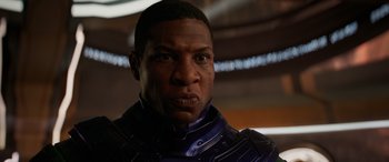 Movie still from “Ant-Man and the Wasp: Quantumania” (2023), directed by Peyton Reed – A person wearing a suit; Close Up shot, Low angle