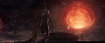 Movie still from “Ant-Man and the Wasp: Quantumania” (2023), directed by Peyton Reed – An image of a woman in a space suit in front of an explosion; Extreme Wide shot, Low angle