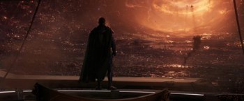 Movie still from “Ant-Man and the Wasp: Quantumania” (2023), directed by Peyton Reed – A man standing on top of a building in front of a city; Extreme Wide shot, Over the shoulder angle