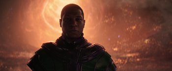 Movie still from “Ant-Man and the Wasp: Quantumania” (2023), directed by Peyton Reed – An african american man wearing a green and purple outfit; Close Up shot, Low angle