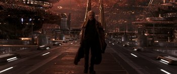 Movie still from “Ant-Man and the Wasp: Quantumania” (2023), directed by Peyton Reed – A man standing on a bridge holding a guitar case; Wide shot, Low angle