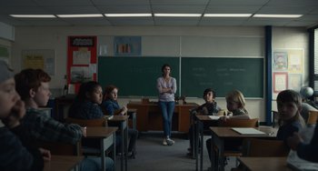 Movie still from “Antlers” (2021), directed by Scott Cooper – A woman standing in front of a group of students; Wide shot, Low angle