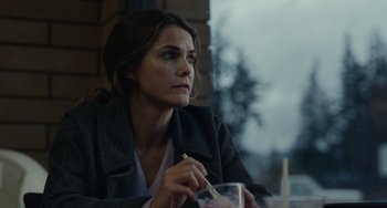 Movie still from “Antlers” (2021), directed by Scott Cooper – A woman sitting in front of a window holding a cup; Close Up shot, Over the shoulder angle