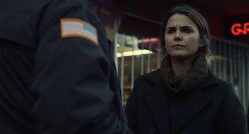 Movie still from “Antlers” (2021), directed by Scott Cooper – A woman standing next to a man in a black jacket; Close Up shot, Over the shoulder angle