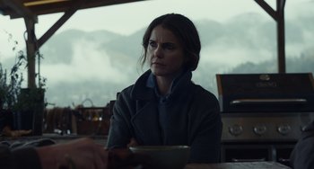 Movie still from “Antlers” (2021), directed by Scott Cooper – A woman sitting at a table with a bowl in front of her; Medium shot, Over the shoulder angle