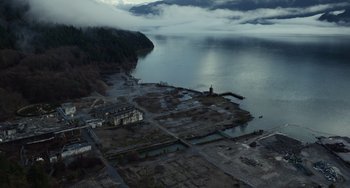 Movie still from “Antlers” (2021), directed by Scott Cooper – An aerial view of an island in the middle of a body of water; Extreme Wide shot, High angle