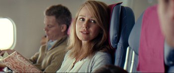 Movie still from “The Impossible” (2012), directed by J.A. Bayona – A woman sitting on a seat on an airplane; Close Up shot, Over the shoulder angle