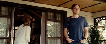 Movie still from “The Impossible” (2012), directed by J.A. Bayona – A man standing in front of an open door; Medium shot, Over the shoulder angle