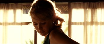 Movie still from “The Impossible” (2012), directed by J.A. Bayona – A beautiful woman standing next to a window in the sunlight; Close Up shot, Low angle
