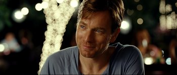 Movie still from “The Impossible” (2012), directed by J.A. Bayona – A person wearing a blue shirt; Close Up shot, Over the shoulder angle
