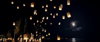 Movie still from “The Impossible” (2012), directed by J.A. Bayona – A bunch of paper lanterns flying in the sky at night; Extreme Wide shot, Low angle