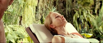 Movie still from “The Impossible” (2012), directed by J.A. Bayona – A woman sitting in a chair with her eyes closed; Close Up shot, Over the shoulder angle