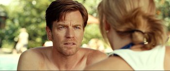 Movie still from “The Impossible” (2012), directed by J.A. Bayona – A person sitting in front of another person; Close Up shot, Over the shoulder angle