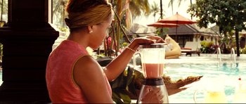 Movie still from “The Impossible” (2012), directed by J.A. Bayona – A woman in a pink shirt is making a smoothie; Medium shot, Over the shoulder angle