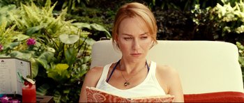 Movie still from “The Impossible” (2012), directed by J.A. Bayona – A woman sitting in a chair reading a book; Close Up shot, High angle
