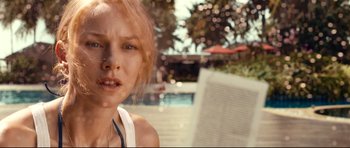 Movie still from “The Impossible” (2012), directed by J.A. Bayona – A person near a swimming pool; Close Up shot, Over the shoulder angle