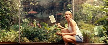 Movie still from “The Impossible” (2012), directed by J.A. Bayona – A woman sitting on the ground in front of a window; Medium shot, High angle