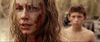 Movie still from “The Impossible” (2012), directed by J.A. Bayona – A person with long brown hair; Close Up shot, Over the shoulder angle
