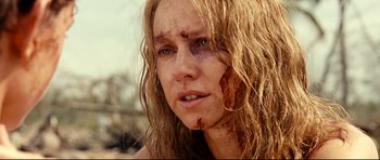 Movie still from “The Impossible” (2012), directed by J.A. Bayona – A person with a wound on their face; Close Up shot, Over the shoulder angle