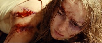 Movie still from “The Impossible” (2012), directed by J.A. Bayona – A person with blood all over her face; Close Up shot, Overhead angle