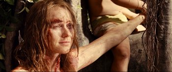 Movie still from “The Impossible” (2012), directed by J.A. Bayona – A young woman is laying on the ground with blood all over her face; Close Up shot, Low angle