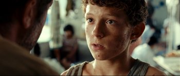Movie still from “The Impossible” (2012), directed by J.A. Bayona – A young boy's face in a room; Close Up shot, Over the shoulder angle