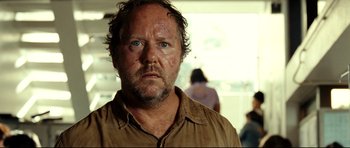 Movie still from “The Impossible” (2012), directed by J.A. Bayona – A person wearing a brown shirt; Close Up shot, Over the shoulder angle