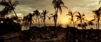 Movie still from “The Impossible” (2012), directed by J.A. Bayona – The sun is setting over the ocean with palm trees in the foreground; Extreme Wide shot, High angle