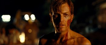Movie still from “The Impossible” (2012), directed by J.A. Bayona – A man with blood all over his face and chest; Close Up shot, Over the shoulder angle