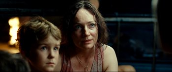 Movie still from “The Impossible” (2012), directed by J.A. Bayona – A person and a child; Close Up shot, Over the shoulder angle