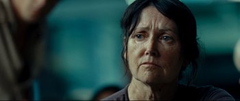 Movie still from “The Impossible” (2012), directed by J.A. Bayona – An older woman with blue eyes stares into the camera; Close Up shot, Over the shoulder angle